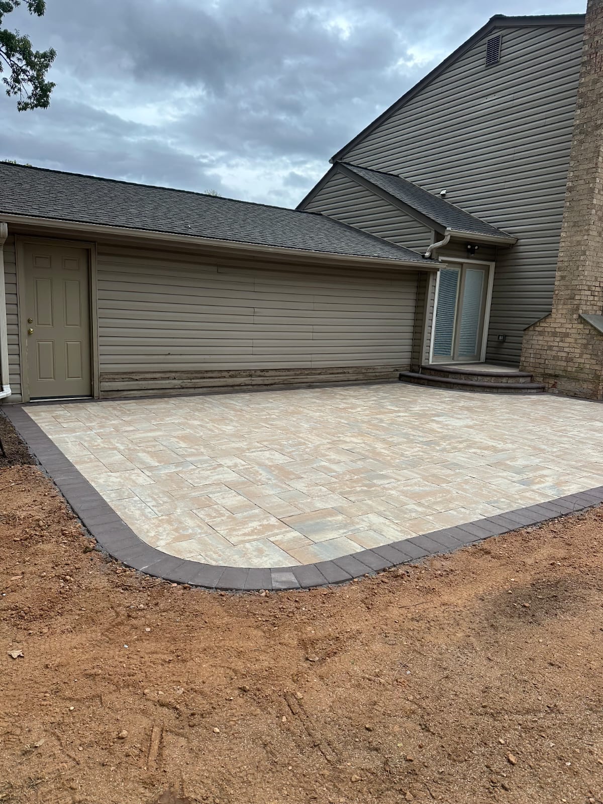Large paver patio finished in warm tan tones